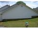 Showing the side of the house with vinyl siding and a gas connection point at 214 Oak Cir, Stockbridge, GA 30281