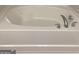 Modern soaking tub features chrome fixtures and a smooth white interior for relaxation at 6398 Lanier Harbor Lndg, Buford, GA 30518