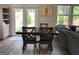 Dining room features a wooden table and backyard views through French doors for easy access to the patio at 6398 Lanier Harbor Lndg, Buford, GA 30518