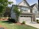 Well-maintained home featuring lush lawn, brick accents and a two-car garage at 6398 Lanier Harbor Lndg, Buford, GA 30518
