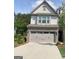 Charming home featuring a two-car garage, brick accents and manicured landscaping at 6398 Lanier Harbor Lndg, Buford, GA 30518