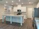 The kitchen offers a large island, white cabinets, and stainless steel appliances at 6398 Lanier Harbor Lndg, Buford, GA 30518