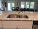 Close up of granite countertops, a sink, and white cabinetry in the kitchen island at 6398 Lanier Harbor Lndg, Buford, GA 30518