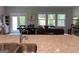 Open concept kitchen features granite countertops, stainless sink and views into the living and dining spaces at 6398 Lanier Harbor Lndg, Buford, GA 30518