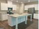 The kitchen features granite countertops, stainless steel appliances, and a large island at 6398 Lanier Harbor Lndg, Buford, GA 30518