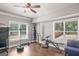 Basement gym area with a punching bag, weightlifting equipment, and bright windows overlooking the backyard at 68 Timber Creek Estates Dr, Sharpsburg, GA 30277