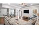 Finished basement featuring a large sectional, TV, and stone accent columns for added style and character at 68 Timber Creek Estates Dr, Sharpsburg, GA 30277