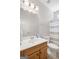 Well-lit bathroom with a wooden vanity, a large mirror, and a shower and bathtub combination at 68 Timber Creek Estates Dr, Sharpsburg, GA 30277