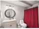 Charming bathroom featuring a pedestal sink, toilet, and shower with a stylish red curtain for privacy at 68 Timber Creek Estates Dr, Sharpsburg, GA 30277