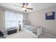 Cozy bedroom showcasing a white trundle bed, storage bench, and a window with bright natural light at 68 Timber Creek Estates Dr, Sharpsburg, GA 30277
