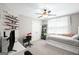 Bright bedroom features a white trundle bed, ceiling fan, mounted display shelves, and a cozy study nook at 68 Timber Creek Estates Dr, Sharpsburg, GA 30277