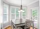 Bright breakfast nook with hardwood floors, large windows, and a chandelier at 68 Timber Creek Estates Dr, Sharpsburg, GA 30277