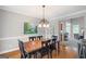 Bright dining room featuring hardwood floors, a large table, and a view into the living room at 68 Timber Creek Estates Dr, Sharpsburg, GA 30277