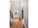 Bright foyer featuring hardwood floors, a staircase, and a view of the front door with decorative glass at 68 Timber Creek Estates Dr, Sharpsburg, GA 30277