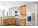 Well-lit kitchen with stainless steel appliances, granite countertops, and wood cabinets at 68 Timber Creek Estates Dr, Sharpsburg, GA 30277