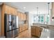 Gourmet kitchen showcases stainless steel appliances, granite countertops, and hardwood floors at 68 Timber Creek Estates Dr, Sharpsburg, GA 30277