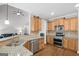 Modern kitchen boasts granite countertops, a stainless steel dishwasher, and hardwood flooring at 68 Timber Creek Estates Dr, Sharpsburg, GA 30277