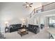 Inviting living room with stairway features comfortable seating, a coffee table, and warm lighting at 68 Timber Creek Estates Dr, Sharpsburg, GA 30277