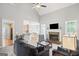 Open-concept living room with fireplace seamlessly connects to the kitchen and dining area at 68 Timber Creek Estates Dr, Sharpsburg, GA 30277