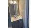 Bathroom vanity has a white marble-style countertop, decorative mirror and gray base cabinet at 554 Windsor Dr, Forest Park, GA 30297