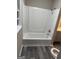 Bathroom featuring a white bathtub and shower combination, gray floors, and neutral walls at 554 Windsor Dr, Forest Park, GA 30297