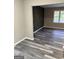 Living room showing gray floors, neutral walls, and an accent wall with geometric design at 554 Windsor Dr, Forest Park, GA 30297