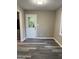 Room showcasing gray floors, a white door with glass panel, and neutral wall paint at 554 Windsor Dr, Forest Park, GA 30297