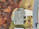 A detailed aerial of a single-Gathering home with a well-manicured lawn and landscaping features at 5760 Winding Lakes Dr, Cumming, GA 30028