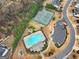Aerial view of the community pool, clubhouse, and tennis courts, showcasing community amenities at 5760 Winding Lakes Dr, Cumming, GA 30028