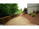 Scenic backyard landscaping with a wood-lined path and a small flower garden at 5760 Winding Lakes Dr, Cumming, GA 30028