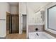 Nicely appointed bathroom featuring a walk-in shower, soaking tub, and classic vanity at 5760 Winding Lakes Dr, Cumming, GA 30028