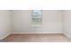 Bright, empty bedroom featuring neutral walls and soft carpeting illuminated by natural light at 5760 Winding Lakes Dr, Cumming, GA 30028