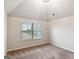Bedroom featuring carpeted floors, neutral walls and large window with neighborhood views at 5760 Winding Lakes Dr, Cumming, GA 30028