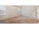 Bright bedroom features plush carpet, neutral walls, and natural light from a pair of windows at 5760 Winding Lakes Dr, Cumming, GA 30028