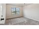 Well-lit bedroom features plush carpet, neutral walls, and a window with neighborhood views at 5760 Winding Lakes Dr, Cumming, GA 30028