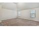 Large bedroom features high vaulted ceilings, carpeted floors and bright windows with views of the neighborhood at 5760 Winding Lakes Dr, Cumming, GA 30028