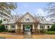 Beautiful clubhouse with stone accents, a gray metal roof, and a gated entrance to the pool area at 5760 Winding Lakes Dr, Cumming, GA 30028