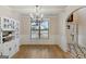 Traditional dining room featuring wainscoting, a chandelier, built-in hutch and beautiful hardwood floors at 5760 Winding Lakes Dr, Cumming, GA 30028