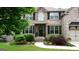 Beautiful brick home with well-manicured landscaping and a welcoming front entrance at 5760 Winding Lakes Dr, Cumming, GA 30028