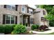 Well-maintained home featuring brick and stone accents, dark shutters, and manicured landscaping at 5760 Winding Lakes Dr, Cumming, GA 30028