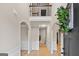 Elegant foyer with high ceilings, arched doorways, and hardwood floors at 5760 Winding Lakes Dr, Cumming, GA 30028