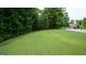 Spacious front lawn with mature trees, offering shade and curb appeal at 5760 Winding Lakes Dr, Cumming, GA 30028