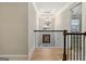 Second floor hallway with view of front window and ornate chandelier at 5760 Winding Lakes Dr, Cumming, GA 30028