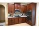 Beautiful kitchen with stainless appliances, dark cabinetry, granite countertops and hardwood floors at 5760 Winding Lakes Dr, Cumming, GA 30028
