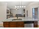 Modern kitchen overlooking an open living room with stainless steel appliances and granite countertops at 5760 Winding Lakes Dr, Cumming, GA 30028