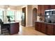Beautiful kitchen with stainless steel appliances, granite countertops, dark cabinetry and hardwood floors at 5760 Winding Lakes Dr, Cumming, GA 30028