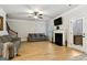 Bright living room featuring a fireplace, hardwood floors, and access to the outside deck at 5760 Winding Lakes Dr, Cumming, GA 30028