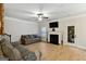 Light-filled living room with hardwood floors, fireplace, and comfortable seating at 5760 Winding Lakes Dr, Cumming, GA 30028