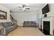 This large living room features a fireplace, ceiling fan and wood floors at 5760 Winding Lakes Dr, Cumming, GA 30028
