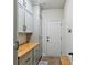 Well-organized mud room with built-in cabinets and butcher block countertop at 5760 Winding Lakes Dr, Cumming, GA 30028
